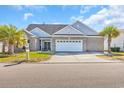 Charming brick home with a two-car garage and tropical landscaping at 2385 Windmill Way, Myrtle Beach, SC 29579