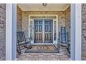 Inviting front porch with double doors and rocking chairs at 2385 Windmill Way, Myrtle Beach, SC 29579