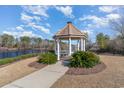 Charming lakeside gazebo with a pathway surrounded by lush greenery at 265 Venice Way # 1-201, Myrtle Beach, SC 29577