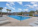 Community pool with crystal clear water and comfortable lounge chairs at 265 Venice Way # 1-201, Myrtle Beach, SC 29577