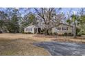 Inviting exterior of a well-kept home with mature trees and an extended driveway at 3281 Long Avenue Ext., Conway, SC 29526