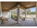 Cozy covered porch with brick flooring and comfortable seating, perfect for relaxing outdoors at 3281 Long Avenue Ext., Conway, SC 29526