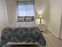 Comfortable bedroom featuring a bed with stylish blue bedding, pillows, and a nightstand with a lamp at 3700 Golf Colony Dr. # 26G, Little River, SC 29566