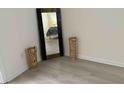 Cozy bedroom with a large mirror and hardwood floors at 3700 Golf Colony Dr. # 26G, Little River, SC 29566