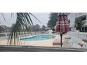 Inviting outdoor pool area with lounge chairs and shade, perfect for relaxation and recreation at 3700 Golf Colony Dr. # 26G, Little River, SC 29566