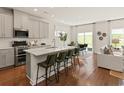 Modern kitchen featuring stainless steel appliances, an island with seating, and hardwood floors at 5052 Riverton Ct, Myrtle Beach, SC 29579