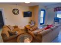 Comfortable living room features a TV, couch, and a large window for natural light at 5905 S Kings Hwy. # 1601-C, Myrtle Beach, SC 29575