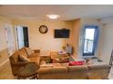 Cozy living room featuring neutral tones, comfortable seating, and access to the outdoor balcony at 5905 S Kings Hwy. # 1601-C, Myrtle Beach, SC 29575