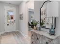 Inviting entryway features a decorative table, mirror, and a glimpse into a dining area, showcasing modern interior design at 597 Haven View Way, Murrells Inlet, SC 29576