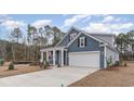 Beautiful home with a manicured lawn, inviting entrance, and a spacious two-car garage, set against a clear sky at 597 Haven View Way, Murrells Inlet, SC 29576