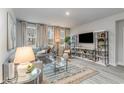 Bright living room with a comfortable sofa, large windows, and stylish decor, offering a cozy and inviting atmosphere at 597 Haven View Way, Murrells Inlet, SC 29576