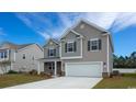 Charming two-story home with a two-car garage, featuring a well-maintained lawn at 6063 Forest Dell Ct, Myrtle Beach, SC 29579
