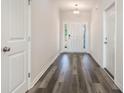 Bright entryway with wood-look flooring and a white front door with sidelights at 621 Woodside Dr., Conway, SC 29526