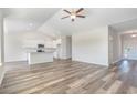 Spacious living room with vaulted ceiling and wood-look flooring open to the kitchen at 621 Woodside Dr., Conway, SC 29526