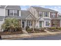 Inviting townhome featuring manicured landscaping, colorful exterior, and a cozy entrance for a welcoming curb appeal at 650 Wilshire Ln., Murrells Inlet, SC 29576