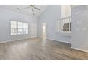 Open-concept living area with light-filled ambiance, a ceiling fan, and light wood floors at 650 Wilshire Ln., Murrells Inlet, SC 29576