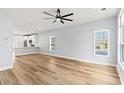 Bright and airy living room with hardwood floors, large windows, and white trim at 6606 Wildwood Trail # E, Myrtle Beach, SC 29572