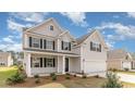 Attractive two-story home featuring gray siding, black shutters, and a welcoming front porch at 7011 Shooting Star Way, Myrtle Beach, SC 29579