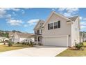 Beautiful two-story home with a two car garage, manicured lawn, and complementary landscaping at 7011 Shooting Star Way, Myrtle Beach, SC 29579