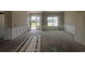 Spacious living room with wainscoting and a glass door leading to the outside, still under construction and awaiting finishes at 713 Horry Rd., Conway, SC 29526