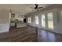 Open-concept living room with wood flooring and modern light fixtures at 713 Horry Rd., Conway, SC 29526