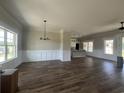 Spacious living room with wood floors, large windows, and modern chandelier at 713 Horry Rd., Conway, SC 29526