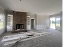 Open-concept living area showcasing a brick fireplace and built-in shelves, still under construction at 713 Horry Rd., Conway, SC 29526