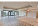 Spacious living room featuring two types of flooring and a wall of windows at 9547 Edgerton Dr. # 204, Myrtle Beach, SC 29572