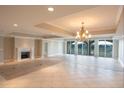 Living room with a fireplace, chandelier, and a wall of windows for natural light at 9547 Edgerton Dr. # 204, Myrtle Beach, SC 29572