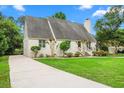 Quaint home with driveway and lush landscaping in front with a walkway leading to the front door at 966 Waterway Ln., Myrtle Beach, SC 29572