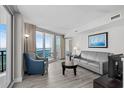 Bright living room featuring stylish furniture and ocean views from a private balcony at 107 S Ocean Blvd. # 601, Myrtle Beach, SC 29577