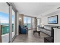 Bright living room featuring stylish furniture and ocean views from a private balcony at 107 S Ocean Blvd. # 601, Myrtle Beach, SC 29577