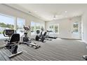 Brightly lit community gym with modern cardio equipment and large windows at 1145 Windy Grove Ln Sw # 16, Ocean Isle Beach, NC 28469