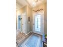 Bright entryway featuring a decorative front door, neutral walls, and modern flooring at 1182 Palm Crossing Dr., Little River, SC 29566