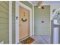 Inviting front door with green wreath and turtle-themed welcome mat at 133 Puffin Dr. # 3-E, Pawleys Island, SC 29585