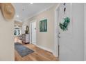 Hallway that features hardwood floors, a decorative mirror, and a view of the living room at 133 Puffin Dr. # 3-E, Pawleys Island, SC 29585