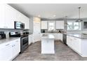 Well-lit kitchen with white cabinetry, stainless steel appliances, and granite countertops at 1411-A N Ocean Blvd., Surfside Beach, SC 29575