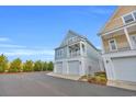 Eye-level exterior of a charming two-story coastal home with a two-car garage at 146 Marblehead Dr., Little River, SC 29566