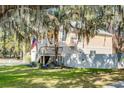 View of a two-story home with a two-car garage, front porch, and fenced in yard at 15 Flaggpoint Ln., Murrells Inlet, SC 29576