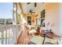 Inviting porch with comfortable wicker furniture, ceiling fans, and neutral paint colors at 15 Flaggpoint Ln., Murrells Inlet, SC 29576