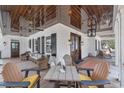 Relaxing outdoor porch with wood ceilings and comfortable seating areas at 161 Twelve Oaks Dr., Pawleys Island, SC 29585