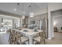 Stylish kitchen island with quartz countertops, stainless appliances and pendant lighting at 171 Glengrove Lane, Murrells Inlet, SC 29576