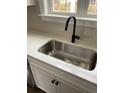 Close-up of a stainless steel sink with a black faucet and white countertops at 171 Glengrove Lane, Murrells Inlet, SC 29576