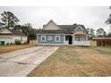 Lovely blue home showcasing a delightful porch and driveway at 1741 Rice St., Georgetown, SC 29440