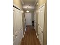 Hallway featuring wood floors, neutral walls, and multiple storage closets at 1742 Low Country Pl. # A, Myrtle Beach, SC 29577