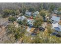 An aerial view of a cozy home nestled among lush green trees in a quiet neighborhood setting at 182 Minnow Dr., Pawleys Island, SC 29585