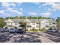 A row of inviting townhomes with convenient parking and lush green spaces at 1826 Low Country Pl. # E, Myrtle Beach, SC 29577