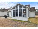 A large screened porch with a high ceiling offering a peaceful outdoor living space at 199 Glenwood Dr., Conway, SC 29526