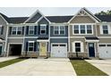 Close up view of modern townhomes featuring garages and coordinated exteriors at 2063 Nw Parow Ln Nw # E, Calabash, NC 28467