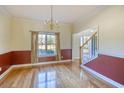 Formal dining room featuring hardwood floors, a chandelier, neutral paint colors, and large window at 221 Hagley Dr., Pawleys Island, SC 29585